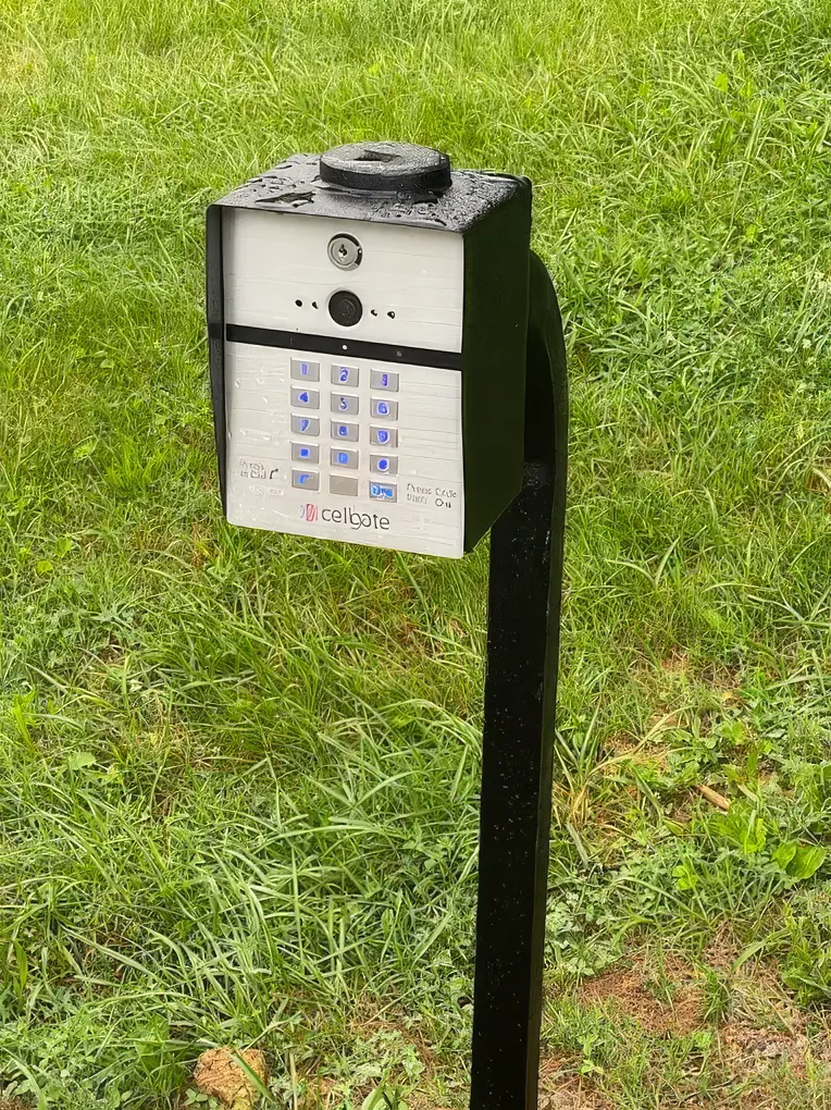 Cellular gate keypad on a steel post for remote entry access control