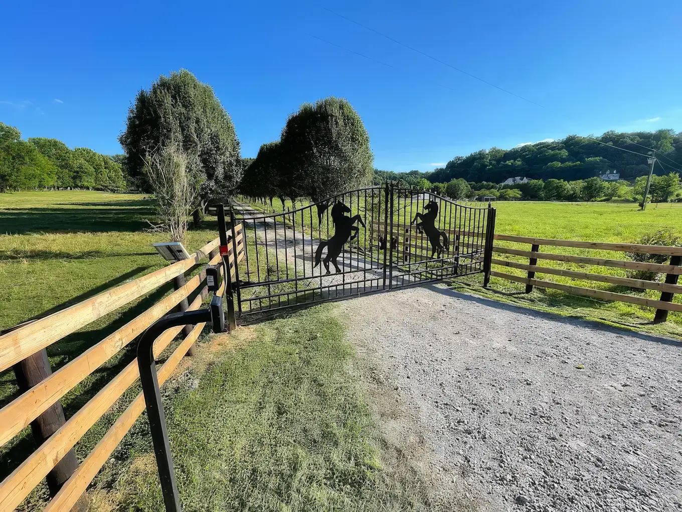 Horse silhouette farm gate between stone columns at a Middle Tennessee estate